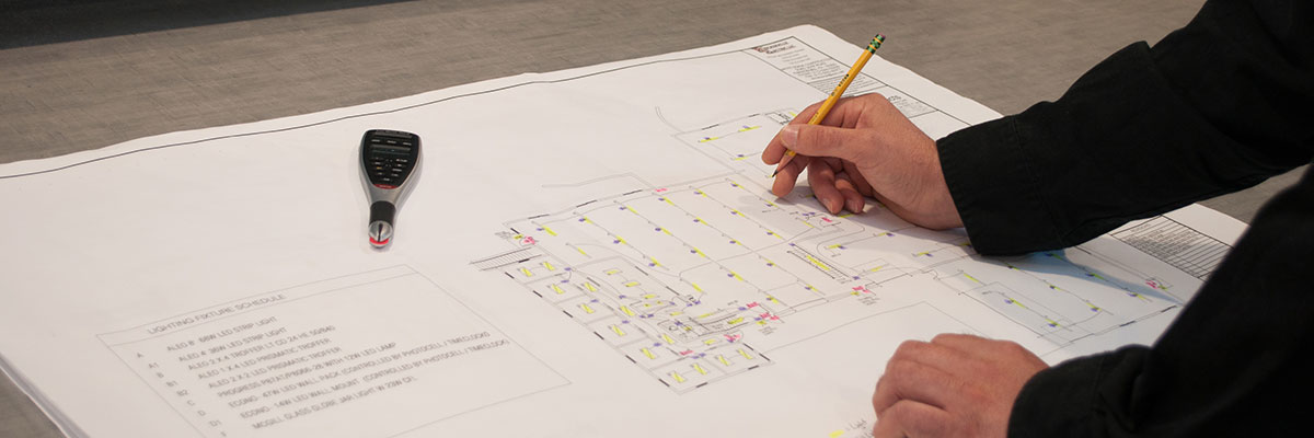 Man Drawing on Building Plans.